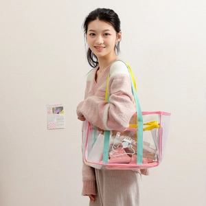 Transparent PVC tote bag with pink trim and colorful straps for beach or travel use