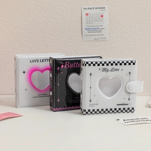 Detailed view of mini 3-ring photo albums with heart cutouts and snap closures