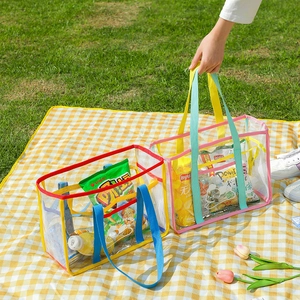 Close-up of vibrant mesh beach bags with durable handles on a picnic mat