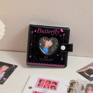 Detail of heart hollow window on a black matte PVC photo album with butterfly graphics