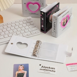 Detailed view of 3-hole heart hollow binder with transparent inner sleeves for photos