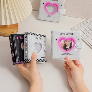 Detail of PVC photo album with heart-shaped window and secure button closure for card storage