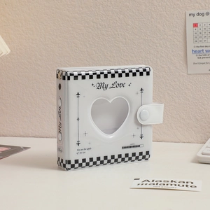 Detail of white checkered mini photo album with heart hollow window and snap fastener