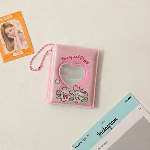 Detail of pink mini card album with heart-shaped window, bunny puppy print, and bead chain