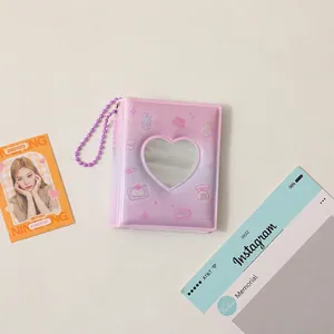 Detail of a purple heart-shaped cutout photo album with cute illustrations and bead chain