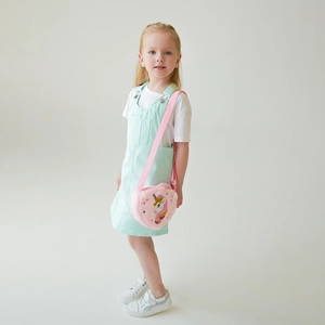 Detailed embroidery of unicorn on pink plush crossbody bag for girls showing material texture