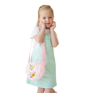 Pink plush heart unicorn crossbody bag shown on child model with adjustable strap