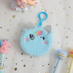 Detail of light blue plush unicorn keychain with rainbow horn and sequined ears