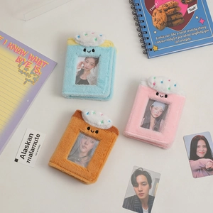 Detailed view of plush 3-inch photocard binders in blue, pink, and tan with cream decor