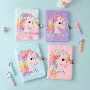 Flat lay of four colorful plush unicorn notebooks with metal locks and fluffy texture