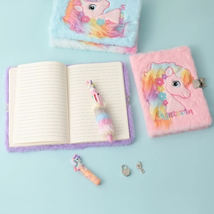 Detail of plush unicorn notebook with heart-shaped lock and matching multicolor pen