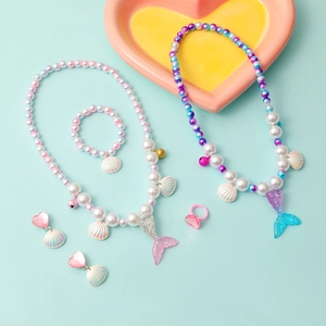 Kids mermaid jewelry set with colorful beaded necklaces, bracelets, and rings in a gift tray