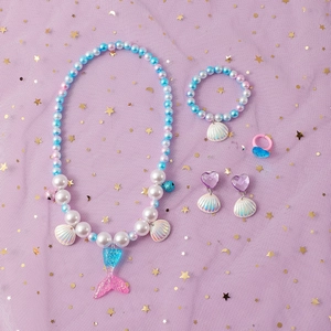 Detail of mermaid jewelry set with blue sequin tail pendant and colorful shell charms