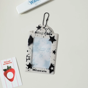 Detail view of a star pattern card holder with black bead chain and pop style graphics