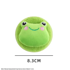 Detail view of a 8.3cm round green plush makeup mirror with cute frog embroidery