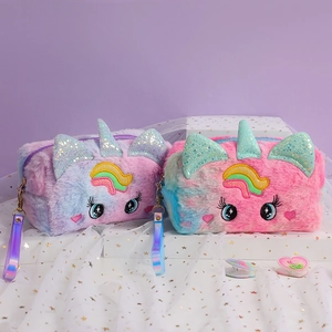 Close-up of fluffy unicorn cosmetic bags featuring rainbow plush and sequin ears