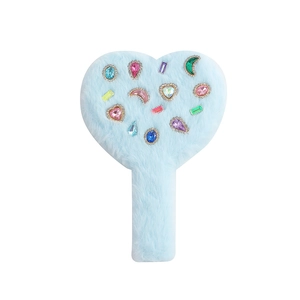 Detail of light blue plush heart hand mirror with colorful gemstone decorations