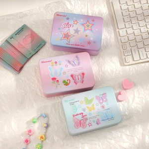 Detailed view of aesthetic metal tin storage boxes with butterfly and star designs