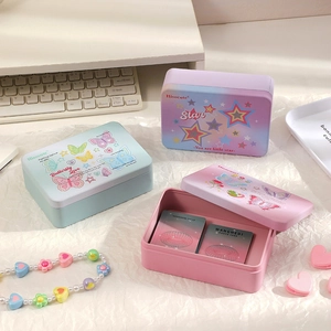 Detail of colorful tinplate storage boxes with star patterns for photo card organization