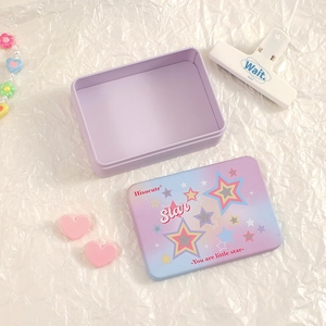 Detail of a purple star pattern tin storage box on a stylish white textured background