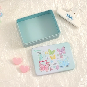 Close-up of light blue tin storage box featuring romantic butterfly illustrations