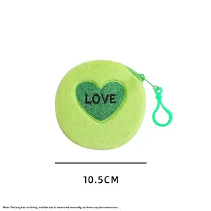 Detail view of round green plush coin purse with 10.5cm diameter and LOVE heart sequin