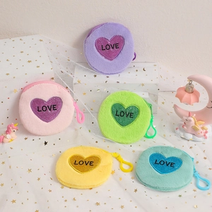 Round plush coin purses with glitter love heart and zip closure in five pastel colors
