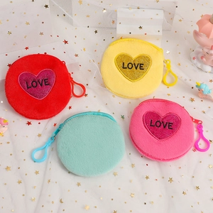 Detailed view of colorful plush heart purses in red, yellow, pink, and mint green