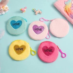 Detail of plush round coin purses with glittery love heart patches and plastic D-rings
