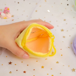 Plush yellow triangular coin purse with zipper and hook shown held in hand