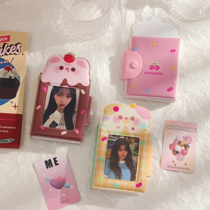 Close-up of PVC photocard albums with cartoon dog patterns and secure snap button closure