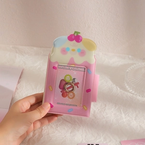Close-up of pink puppy-shaped photocard holder with glossy PVC texture and cute cherry decor