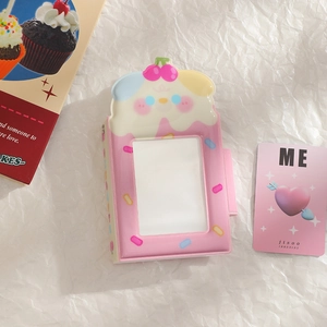 Pink cartoon card holder with cherry charm and clear window on white textured paper
