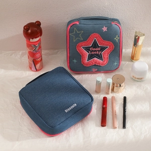 Square denim makeup bag with red star embroidery and pink zipper for travel storage