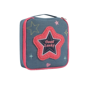 Blue denim makeup bag with pink star embroidery and Good Lucky text on white background