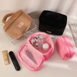 Detail view of large plush cosmetic bag featuring a secure zipper and mesh inner pocket
