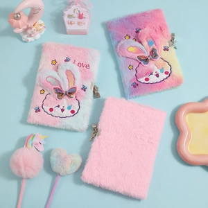 Detail of plush A5 bunny notebook with security lock and matching decorative creative pens