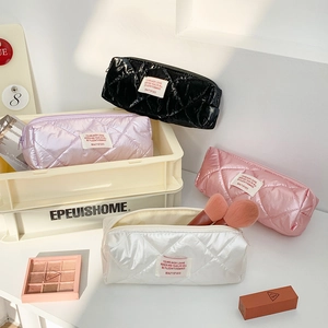 Quilted cosmetic bags in black, purple, pink and white with diamond stitch patterns
