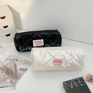 Quilted nylon makeup bag in black and cream white with stylish rhombus pattern