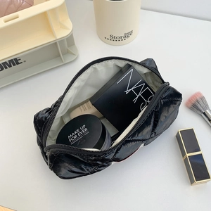 Quilted black puffer pencil case with glossy finish for stationery and makeup storage