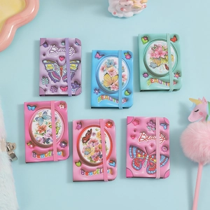Close-up of mini butterfly pocket notebooks in six pastel colors with elastic bands