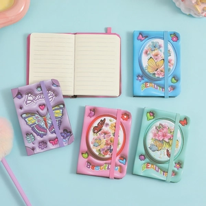 Mini butterfly pocket notebooks in four pastel colors with elastic closure and lined pages
