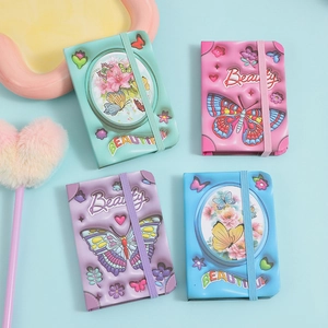 Close-up of colorful puffy mini notebooks with 3D butterfly patterns and elastic bands