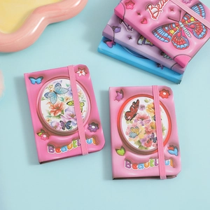 Detailed macro view of 3D embossed butterfly patterns on a pastel mini journal notebook