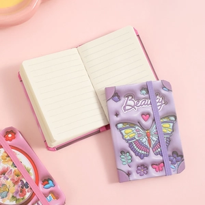 Detail of cartoon butterfly notebook featuring embossed cover and elastic strap with lined pages