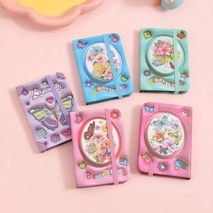 Five assorted mini butterfly floral notebooks with elastic bands in pastel colors