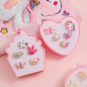 Detail of colorful cartoon unicorn and rainbow resin rings set in heart gift box