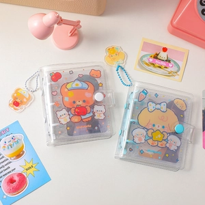 Detail of 3-hole clear PVC mini photo album with cute bear illustration and acrylic charm
