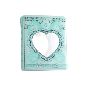 Detail of mint green mini photo album with heart-shaped cutout and lace pattern edges