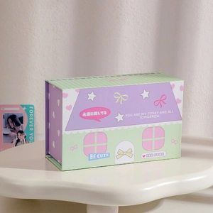 Detailed view of a purple and green house-shaped storage box with cute heart patterns